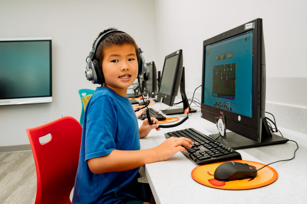 Student with headphones at computer